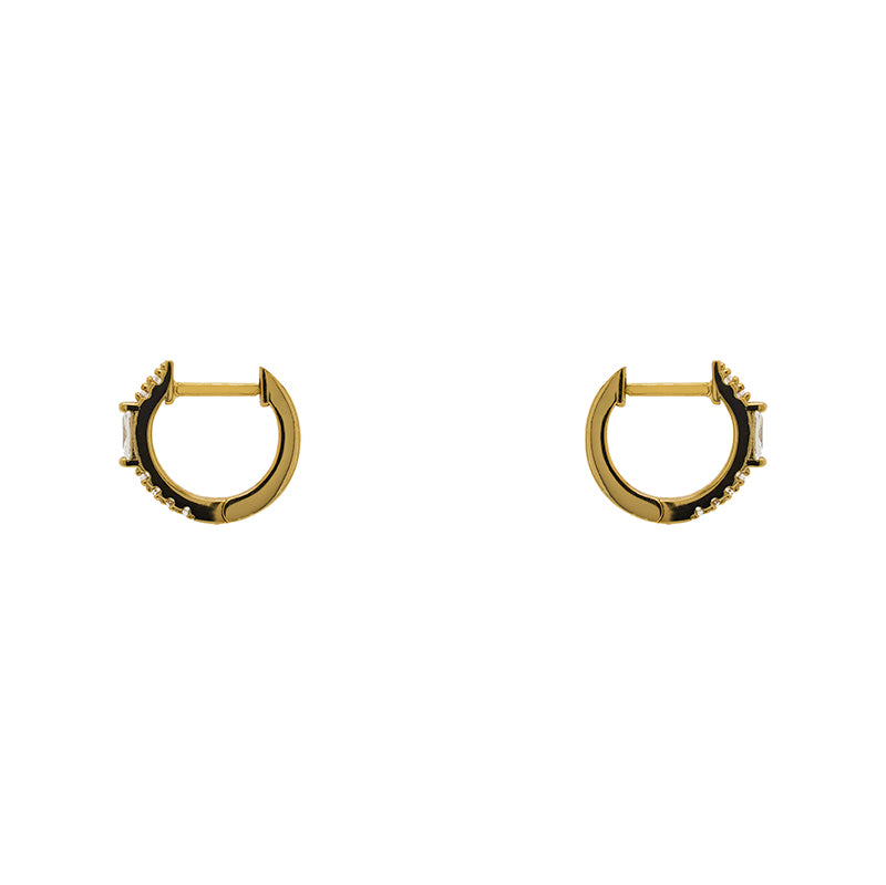 
                  
                    Load image into Gallery viewer, A pair of huggie style earrings with round and baguette crystals in a 14 kt yellow gold vermeil setting. Displayed side facing on a white background.
                  
                