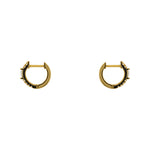 A pair of huggie style earrings with round and baguette crystals in a 14 kt yellow gold vermeil setting. Displayed side facing on a white background.