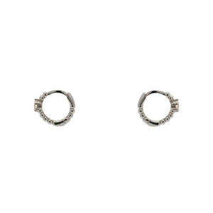 
                  
                    Load image into Gallery viewer, A pair of huggie style earrings each with a dot pattern and 2.5 mm crystal and made of sterling silver. Displayed side facing on a white background.
                  
                