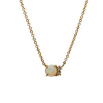 A Cabochon opal cluster necklace with two round cut diamonds cast in 14 kt yellow gold.