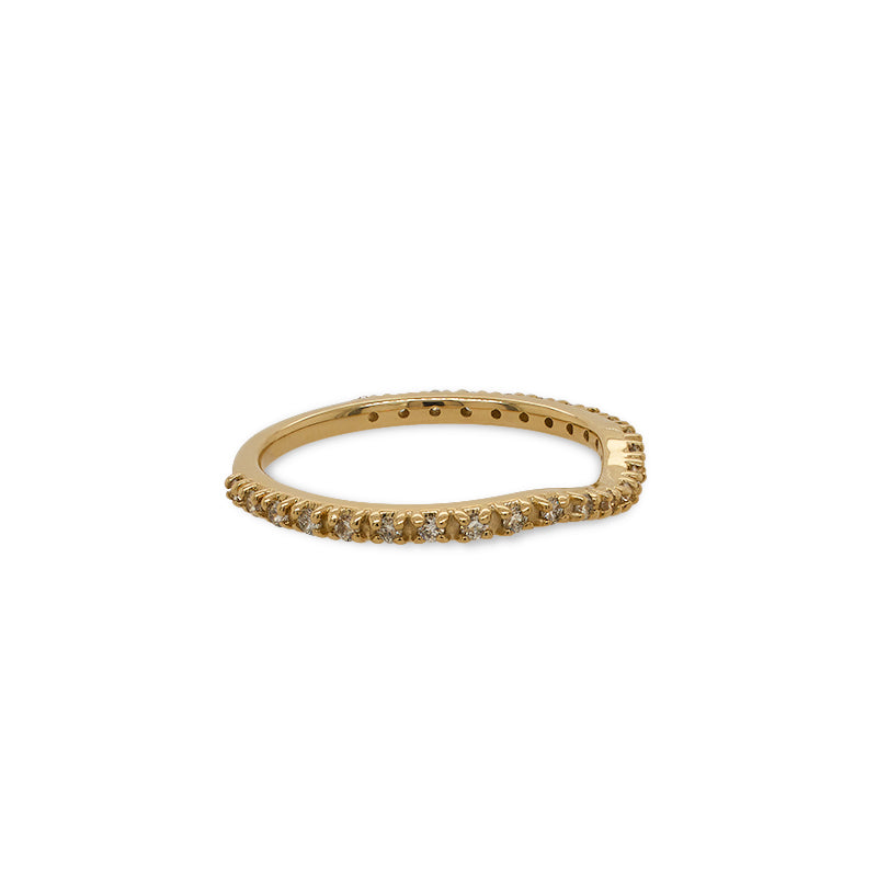Side view of a dainty shadow band with a subtle dip in the center that has 25 small, prong set diamonds in a 14 kt yellow gold setting.