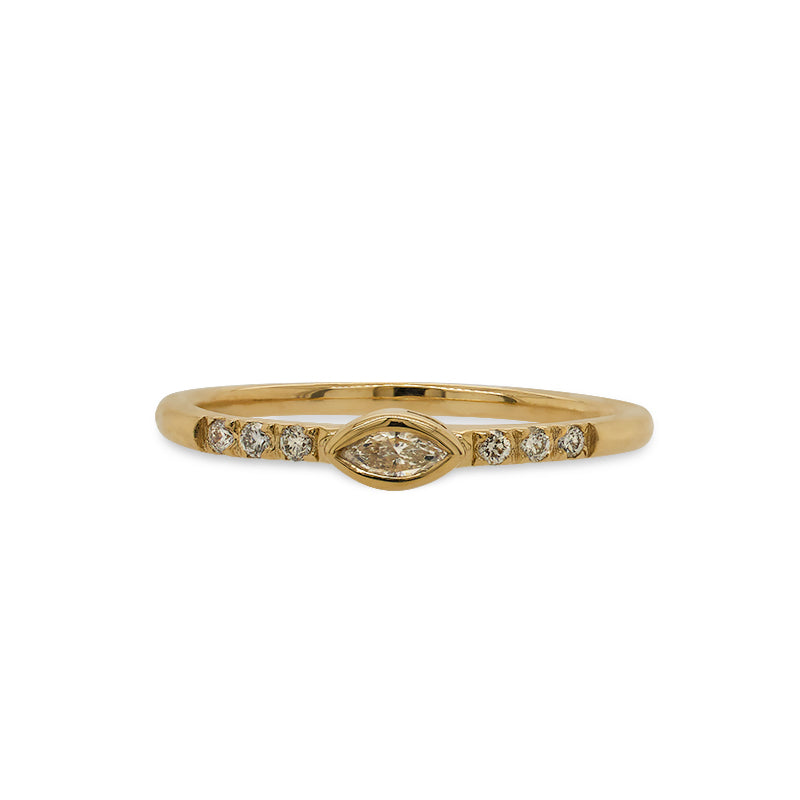 Front view of a 14 kt yellow gold ring with an east west, bezel set marquise diamond in the center and 3 smaller, round diamonds on either side.