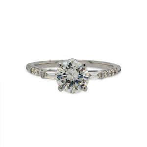 
                  
                    Load image into Gallery viewer, Front view of a round cut diamond engagement ring made of 14 kt white gold with baguette and round cut diamonds going down the shank.
                  
                