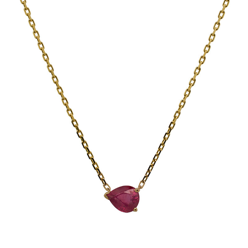 A solitaire, pear cut ruby necklace cast in 14 kt yellow gold on a white background.