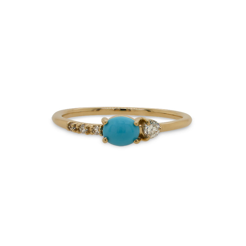 Front view of asymmetrical cabochon turquoise ring with 3 small diamonds and 1 medium size diamond.