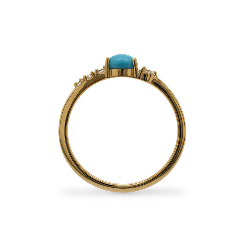 Through the finger view of an asymmetrical cabochon turquoise ring with 3 small diamonds and 1 medium size diamond and cast in 14 kt yellow gold.