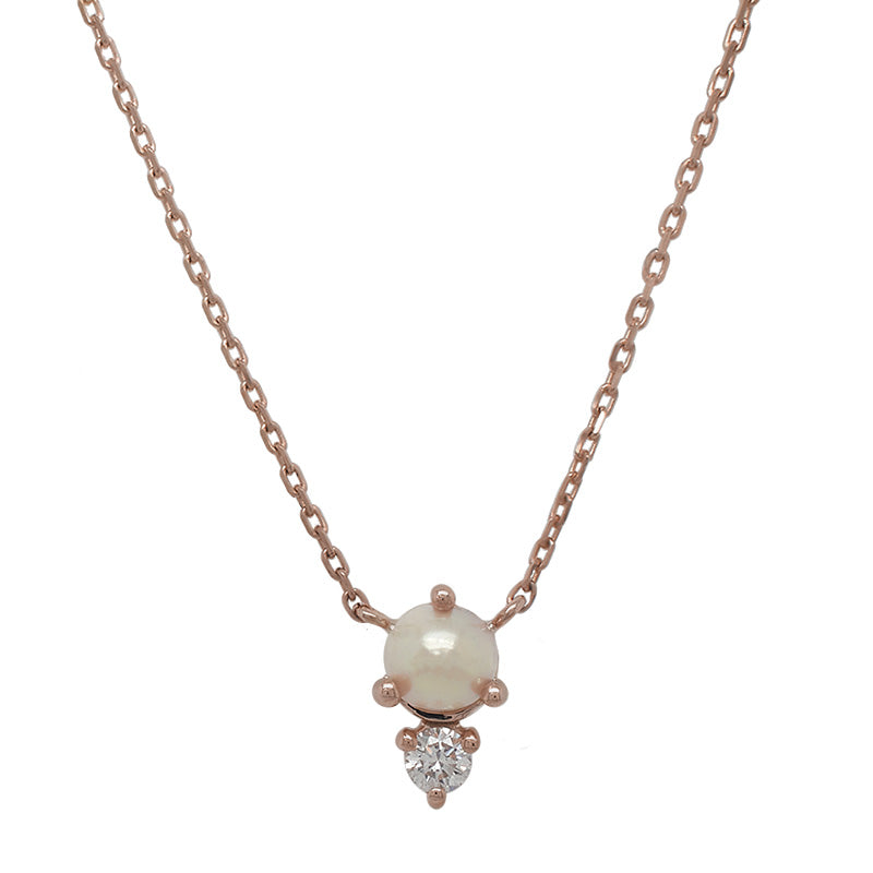 
                  
                    Load image into Gallery viewer, Front view of a cabochon pearl and round cut diamond necklace cast in a 14 kt rose gold north-south setting.
                  
                