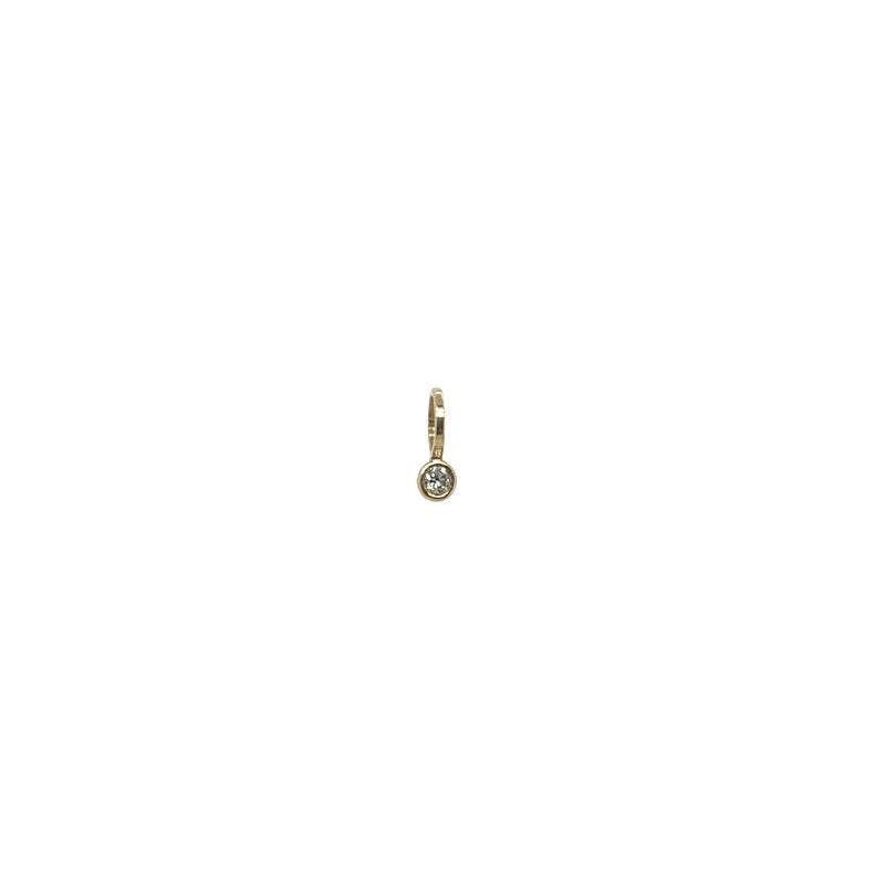 A small yellow gold charm with a single bezel set diamond shown on a white background.