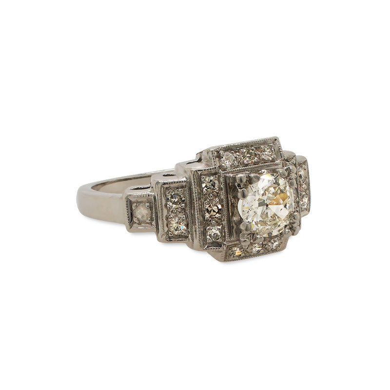 
                  
                    Load image into Gallery viewer, Side view of an Edwardian Deco style ring made of platinum with just under a half carat old euro cut center diamond that is surrounded by 0.27 tcw of single cut round diamonds.
                  
                