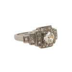 Side view of an Edwardian Deco style ring made of platinum with just under a half carat old euro cut center diamond that is surrounded by 0.27 tcw of single cut round diamonds.