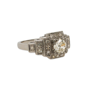 
                  
                    Load image into Gallery viewer, Side view of an Edwardian Deco style ring made of platinum with just under a half carat old euro cut center diamond that is surrounded by 0.27 tcw of single cut round diamonds.
                  
                