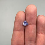 View of 1.02 ct. rounded trillion blue-violet sapphire on ladies hand for scale.