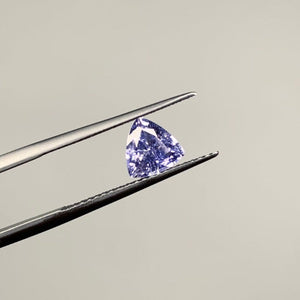 
                  
                    Load image into Gallery viewer, View of 1.02 ct. rounded trillion blue-violet sapphire in tweezers.
                  
                