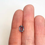 View of a 1.68 ct. blue oval sapphire in ladies hand for scale.