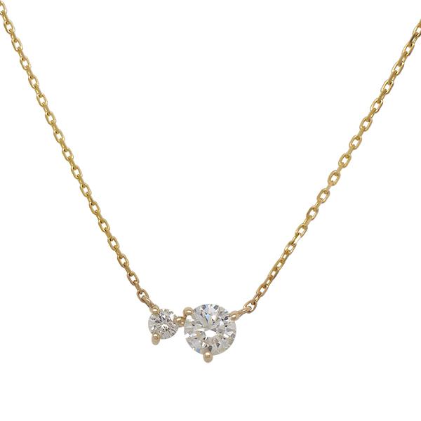 Front view of an asymmetrical round cut double diamond necklace cast in 14 kt yellow gold.