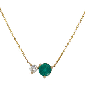
                  
                    Load image into Gallery viewer, Front view of an asymmetrical round cut emerald and diamond necklace cast in 14 kt yellow gold.
                  
                