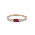 Front view of baguette cut ruby and round diamond ring cast in 14 kt yellow gold.