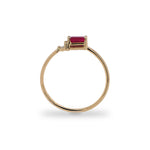 Side view of baguette cut ruby and round diamond ring cast in 14 kt yellow gold. 