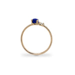 Side view of blue lapis and diamond ring cast in 14 kt yellow gold.