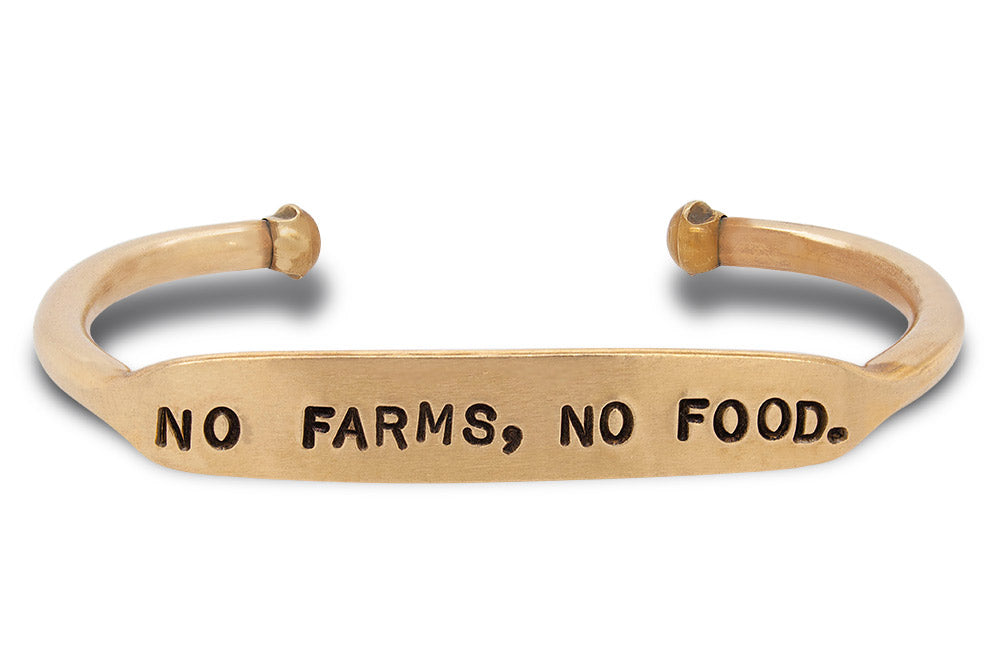 Hand stamped, solid brass cuff that says "no farms, no food."