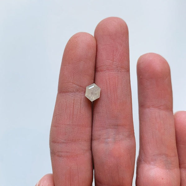 Front view a 1.28 ct. icy hexagon cut diamond on ladies hand for scale.
