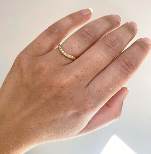 
                  
                    Load image into Gallery viewer, View of a princess cut diamond shadow band on wearer&amp;#39;s left ring finger with 7 princess cut diamonds with a tcw of 0.11, and cast in 14 kt yellow gold.
                  
                