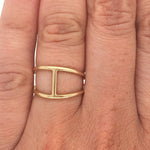 Double band bar ring cast in 14 kt yellow gold on left ring finger.