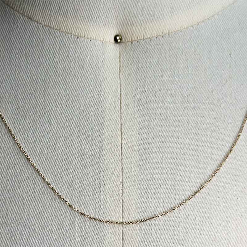 
                  
                    Load image into Gallery viewer, Close up of a dainty, solid 14 kt yellow gold rope style chain on a body form for scale.
                  
                