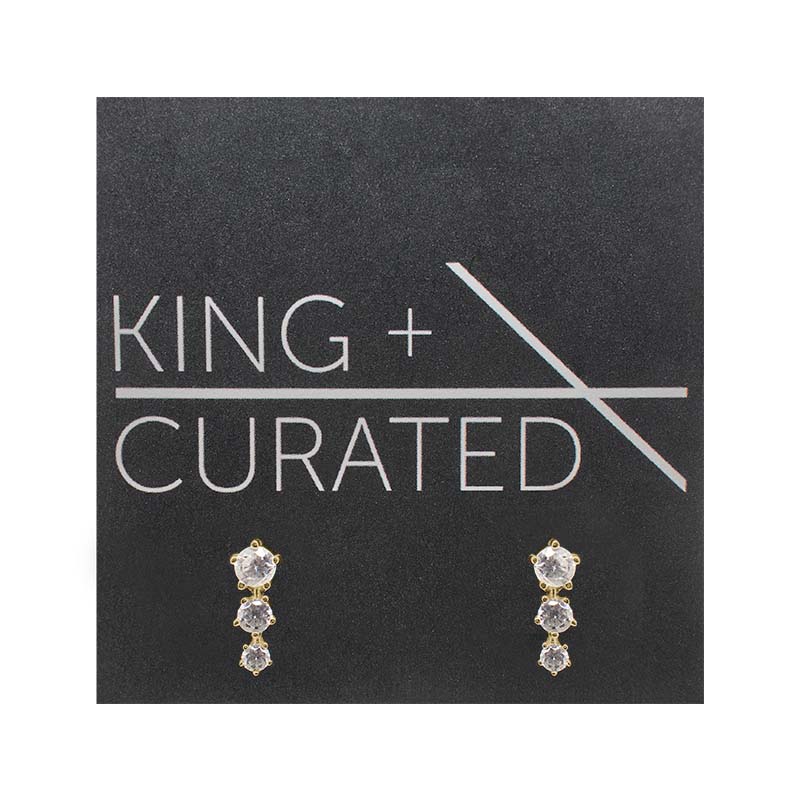 
                  
                    Load image into Gallery viewer, A pair of vertically stacked, triple crystal studs set in 14 kt yellow gold vermeil settings on King and Curated packaging.
                  
                