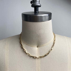 
                  
                    Load image into Gallery viewer, Front view on dress form of flat-link, squared edge paperclip necklace, cast in 14kt yellow gold.
                  
                