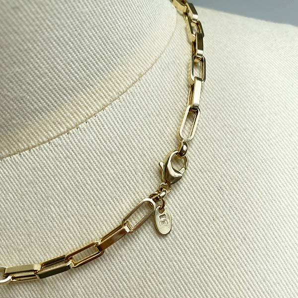 
                  
                    Load image into Gallery viewer, Close up of flat-link, squared edge paperclip necklace and lobster clasp, cast in 14kt yellow gold.
                  
                