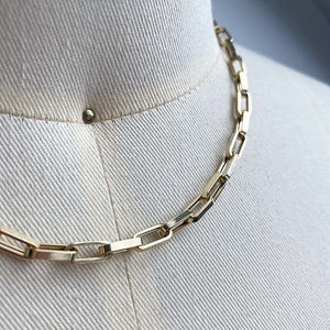 
                  
                    Load image into Gallery viewer, Close up of smaller sized, flat-link, squared edge paperclip necklace, cast in 14kt yellow gold.
                  
                