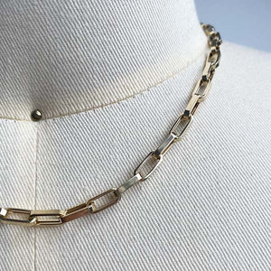 
                  
                    Load image into Gallery viewer, Close up of larger, flat-link, squared edge paperclip necklace, cast in 14kt yellow gold.
                  
                
