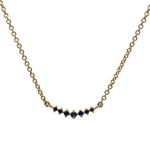 
                  
                    Load image into Gallery viewer, Front view of a graduated, blue sapphire necklace with 7 round cut sapphires set in 14 kt yellow gold.
                  
                