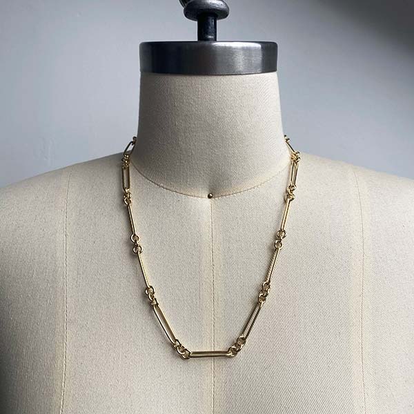 Front view of larger paperclip chain with 3 round link pattern on dress form. 14kt yellow gold and approx 20" length example.