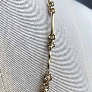 
                  
                    Load image into Gallery viewer, Close up image of larger paperclip chain with 3 round link in 14kt yellow gold.
                  
                