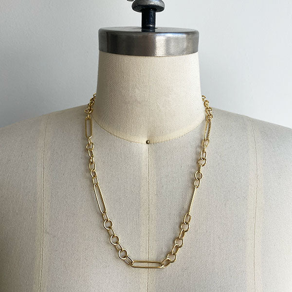 Front view of paperclip chain on dress form with a 7 round link pattern between each paperclip  link.  Shown in 14kt yellow gold and approx 20" length.