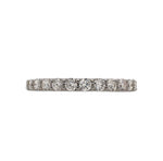 Front view of a half eternity band with round cut diamonds cast in 14 kt white gold. 