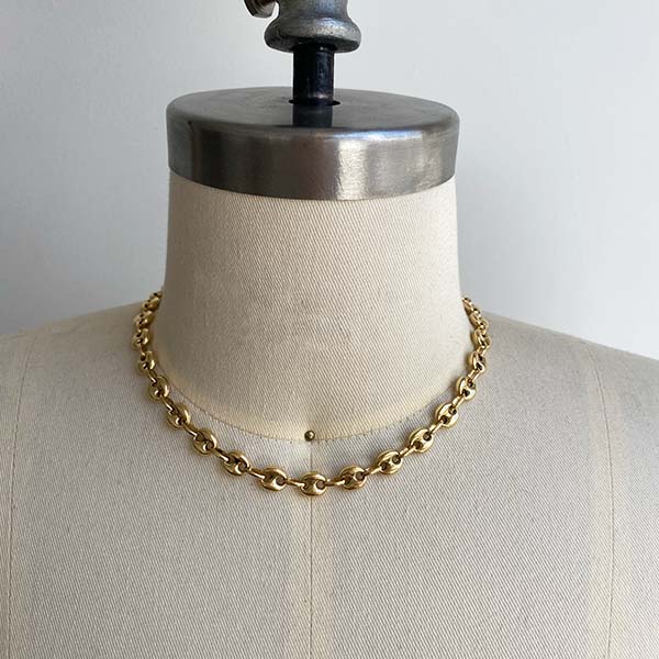 Front view of larger mariner link 16" necklace on dress from. Cast in 14kt yellow gold.