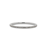 Front view of a micro pavé diamond eternity band cast in 14 kt white gold from King + Curated.