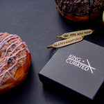 Two brass cuffs and donuts from the  King + Curated and NoFoDoCo collaboration.