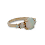 Side view of an asymmetrical opal and diamond ring cast in 14 kt yellow gold.