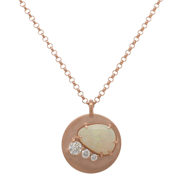Front view of a cabochon cut opal and triple round cut diamond pendant necklace made of solid 14 kt rose gold.