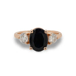 Front view of oval cut black sapphire and round cut diamond ring set in 14 kt rose gold.