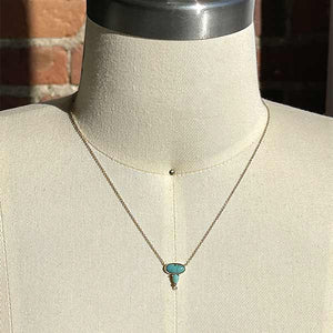 
                  
                    Load image into Gallery viewer, Oval and pear cut turquoise and round diamond necklace cast in 14 kt yellow gold on a body form.
                  
                