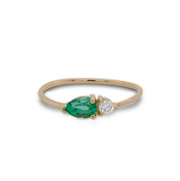 Front view of pear cut emerald and round diamond ring cast in 14 kt yellow gold.