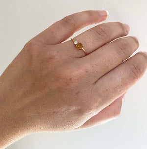 
                  
                    Load image into Gallery viewer, Front view on left ring finger of cabochon cut citrine and round cut diamond ring cast in 14 kt yellow gold.
                  
                
