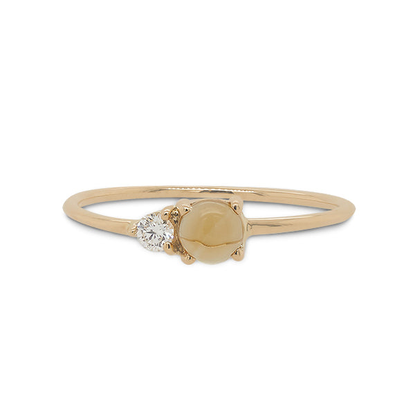 Front view of cabochon cut citrine and round cut diamond ring cast in 14 kt yellow gold.