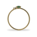 Side view of a round cut green tourmaline and diamond ring cast in 14 kt yellow gold.