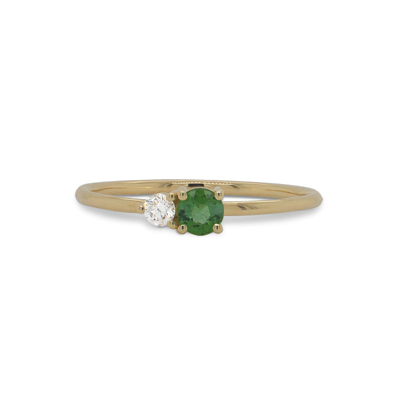 Front view of a round cut green tourmaline and diamond ring cast in 14 kt yellow gold.